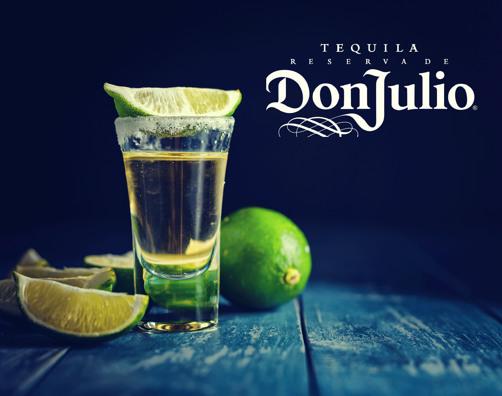 Shot of Don Julio tequila with lime wedges and salt on a rustic surface, representing premium tequila branding.